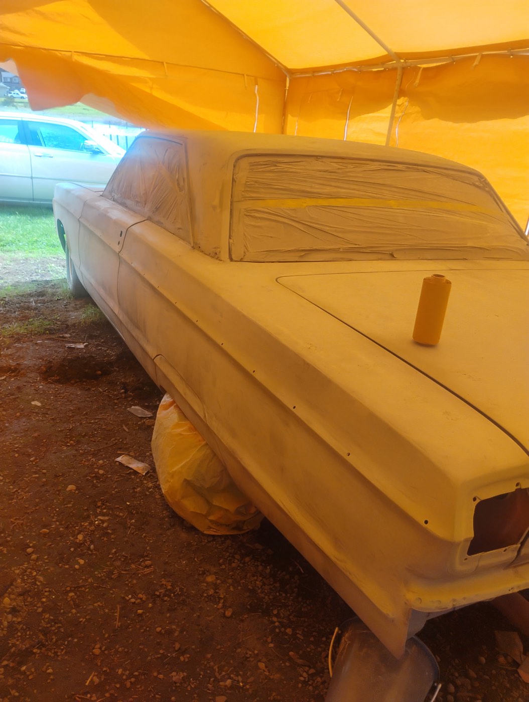 Classic truck during body preparation under a paint tent